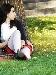 12 pictures - Hot brunette shows stockings up skirt