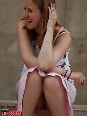 12 pictures - Sitting upskirt. Cutie voyeured in public place