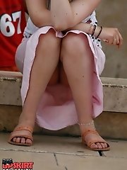 12 pictures - Sitting upskirt. Cutie voyeured in public place