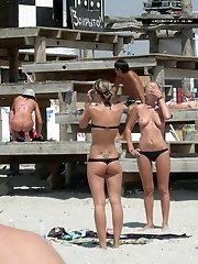 10 pictures - A busty bikini girl undressing on the Coralita