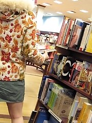 12 pictures - Sneaky upskirt, in a shop. Chubby chick in mini voyeured