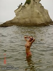 15 pictures - Beautiful girls without bras pose in wet bikinis