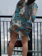12 pictures - Wind upskirt - Wind lifts her dress's skirt up
