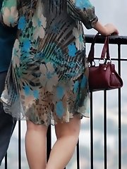 12 pictures - Wind upskirt - Wind lifts her dress's skirt up