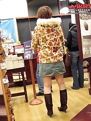 12 pictures - Sneaky upskirt, in a shop. Chubby chick in mini voyeured